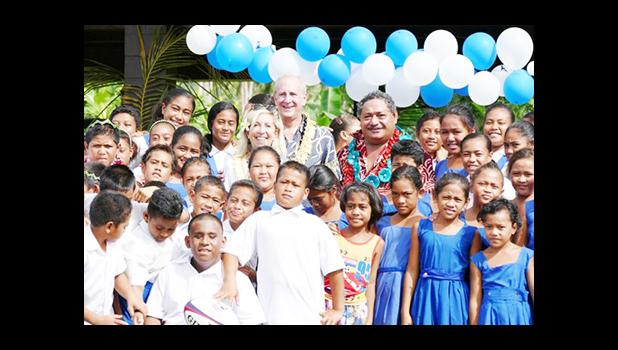 WORK IN SAMOA: Ambassador Mark Gilbert and his wife Nancy Gilbert with Samoan students during one of his recent visits. [Samoa Observer] 