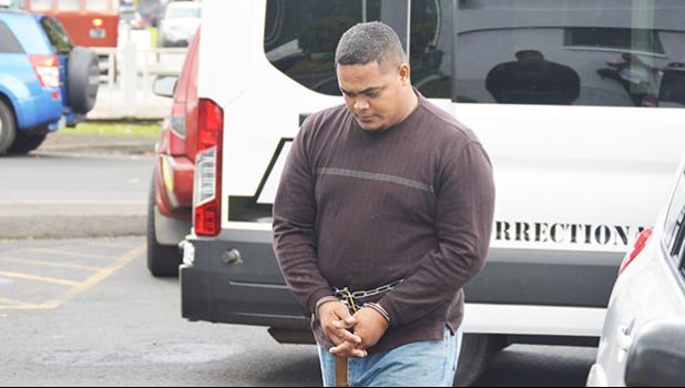 Amosa Lautaimi, handcuffed and making his way to the District Court yesterday morning for his initial appearance