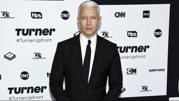FILE - In this May 17, 2017, file photo, CNN News anchor Anderson Cooper attends the Turner Network 2017 Upfront presentation at The Theater at Madison Square Garden in New York. Several online sites and President Donald Trump supporters shared photos of Cooper, falsely accusing him of faking Hurricane Florence’s wrath. The claims were made after Donald Trump Jr., the president’s son, tweeted a photo of Cooper in waist-deep flood waters, while his camera crew stood a few feet away in water up to their ankles. In his tweet, sent over the weekend as Hurricane Florence unleashed winds, rains and floods across the East Coast, Trump called on the television network to “stop lying” about his father. Trump Jr. did not specifically mention Hurricane Florence in his social media post, but several social media users and online sites wrongly concluded the picture of Anderson was taken during Hurricane Florence. (Photo by Evan Agostini/Invision/AP, File) CNN News anchor Anderson Cooper in a 2017 AP file photo