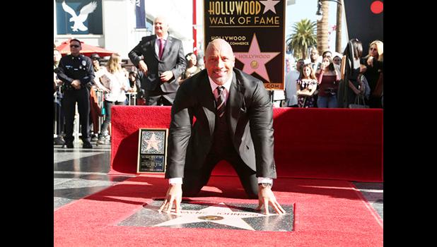 Dwayne Johnson poses for a photo at his star ceremony at the Hollywood Walk of Fame on Wednesday, Dec. 13, 2017, in Los Angeles. (Photo by Willy Sanjuan/Invision/AP) Dwayne Johnson poses for a photo at his star ceremony at the Hollywood Walk of Fame on Wednesday, Dec. 13, 2017, in Los Angeles. (Photo by Willy Sanjuan/Invision/AP)