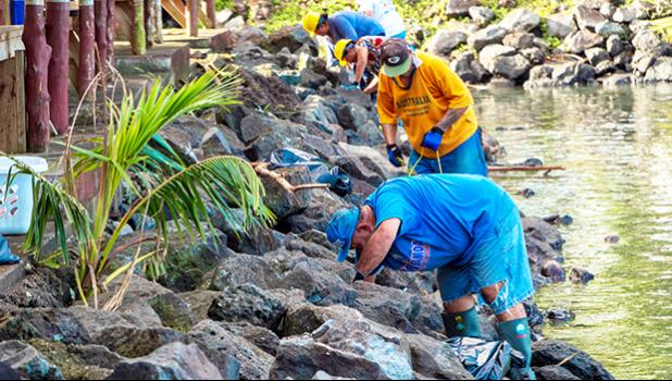 Members of the Pago Pago Seventh-Day Adventist Church picking up debris