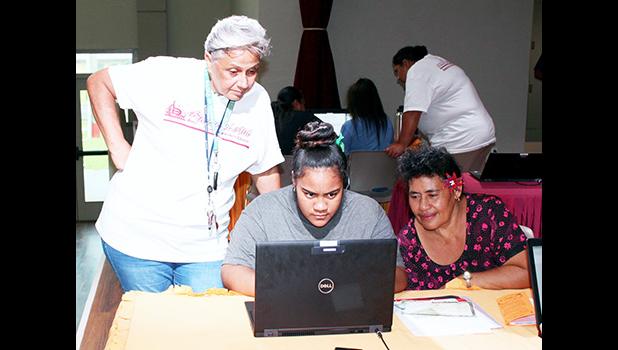 ASCC Counselor Josie Willis-Tuisamoa (left) guides a student and parent through the ASCC admissions process