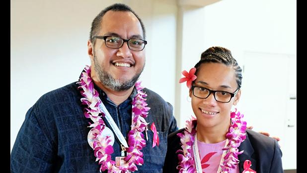 Derek Helsham (left) congratulates ASCC alumnus Alice Tausaga