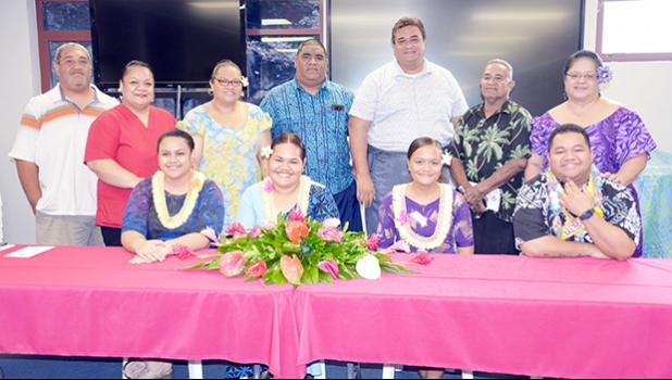 The 4 graduates (seated) and Scholarship Board chairman, Sen. Fai’ivae Godinet and co-chair Donna Gurr recognized the four students and their parents (standing)
