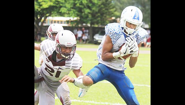 The Most Valuable Player of the Game, Elliot Lelei storming towards the end zone to score the first touchdown for Samoana High School — late in the second quarter — which tied up the ball game at six a piece, during the ASHSAA Football Championship game, last Saturday. Lelei also kicked the field goal to give the Blue Empire the 7- 6 lead, which they held throughout the match for their 1st ASHSAA Varsity football championship in 8 years. The Sharks also won the JV division this year.  [photo: TG]