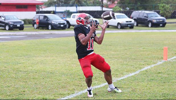Jacob Umu of Faga’itua catching the opening touchdown of the game in the first quarter of play in their Varsity game against the Samoana Sharks this past Friday evening. The Vikings lost to the Sharks 14 - 12.  [photo: TG]