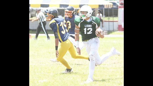 Raymond Paulo, the ‘Iron Man’, taking his second touchdown catch to the end zone – Leone’s second touchdown of the game during the opening half of their varsity match up against the Wildcats last Saturday afternoon. Paulo led the Lions to a 32-0 victory over Nu’uuli.  [photo: TG]