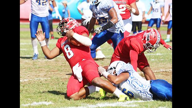 Vito Kitiona of the Vikings is sacked in the backfield by a Samoana defender, during the second quarter of their playoff game this past Saturday at the Veterans Memorial Stadium. The Vikings lost to the Sharks 19-16. [photo: TG]