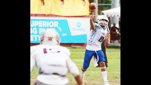 Anthony Feala of the Sharks firing a receiver screen pass out to Zephaniah Pati, during the third quarter of their varsity championship game against the Warriors. Feala and the Sharks claimed this year's ASHSAA title after a 7-6 win over Tafuna last Saturday morning.  [photo: TG]