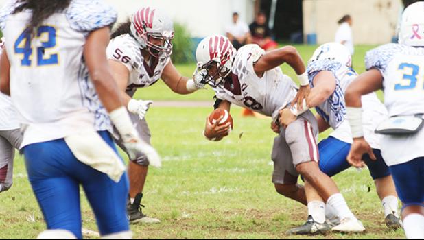 Tala Sufia is sacked by Fa’avae of the Sharks behind the line of scrimmage for a loss. Fa’avae led the Sharks in shutting out the Warriors in the opening quarter of last Saturday's championship game. [photo: TG]