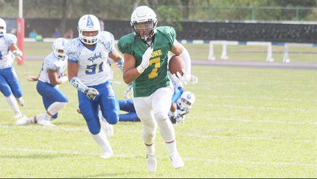 Leone's Iverson Ta’ase racing to the sidelines as he gains huge yardage for the Lions on this run, during the opening half of a varsity game against Samoana this past Saturday. [photo: TG]