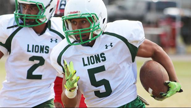 A Leone Lions running back, carrying the ball during the second half of a junior varsity game against the Vikings. Leone lost 0-16 in their second game of the regular season.  [photo: TG]