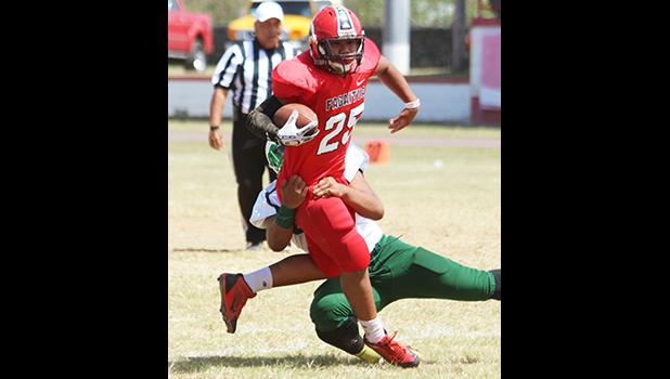 Jessie Toilolo getting tackled in the backfield by a Leone defender in the second half of a JV game last Saturday,  between the Lions and the Vikings. Toilolo helped the Vikings to a 16-0 win. [photo: TG]