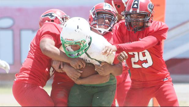 Leone’s quarterback getting sacked in the back field by three Viking defenders in the opening quarter of a JV game last Saturday.  [photo: TG]