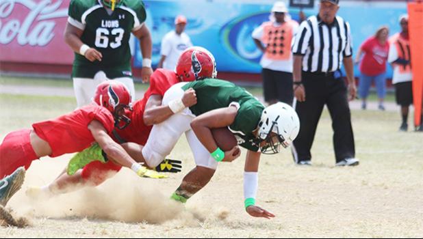 Iverson Ta’ase of the Lions trying to recover from a tackle in the third quarter of a varsity game against the Vikings last Saturday. Faga'itua won 50-20 in their second game of the regular season. [photo: TG]