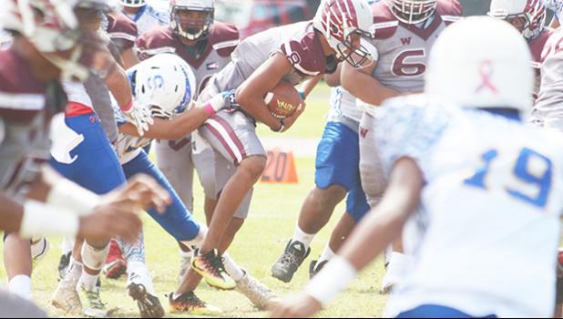 Francisco Mauigoa getting sacked immediately in the backfield by Daniel McMoore for a loss. [photo: TG]