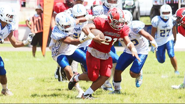 The hardest working Viking last Saturday was Pitonu’u Ah-Sue – seen here refusing to go down. Ah-Sue, known as one of the most relentless runners in the league, led the Varsity Vikings to a 30-14 victory in their senior game against the Samoana Sharks. [photo: TG]