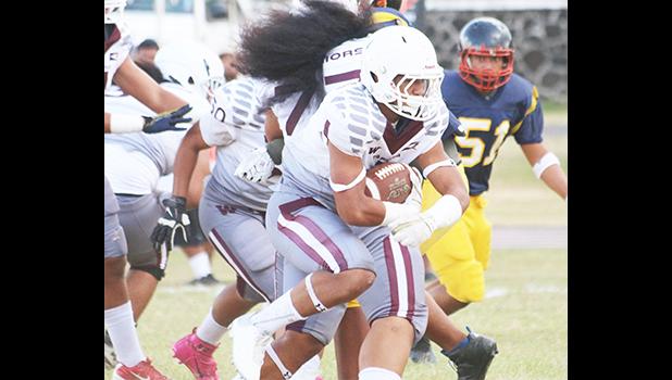 Tafuna Warriors' Panapa Filoiali’i making his way past the goal lines for another Tafuna touchdown in the first half of a Varsity match against Nu’uuli Vo-Tech last Saturday morning. Filoiali’i led the Warriors to a 54-6 victory against the Wildcats. [photo: TG]