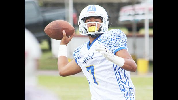Jr. ‘Jam’ Tanielu of Samoana looking downfield and charging up to fire a long one to his receiver. Samoana blew out Tafuna 46-8 in JV competition. [photo: TG]