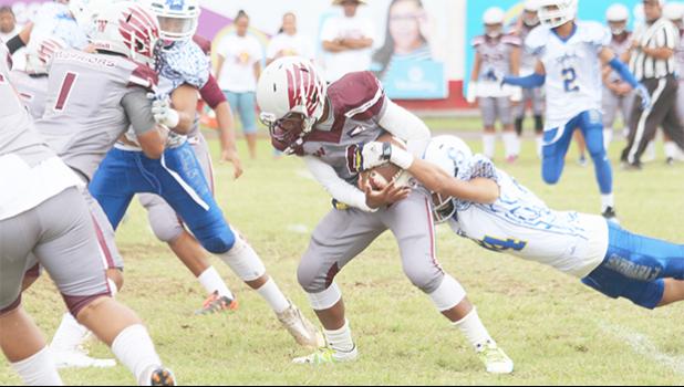 Tafuna’s kick off returner was immediately apprehended in the backfield by a Samoana Shark, during the opening quarter of a Junior Varsity match up last Saturday morning.  [photo: TG]