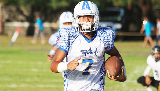 Samoana Sharks quarterback, Jr. Tanielu running in his second eighty plus yard quarterback keep for a touchdown. Tanielu led the Sharks with 3 touchdown receptions, all from quarterback keeps, in their 32- 8 victory over the Wildcats, last Friday evening.  [photo; TG]