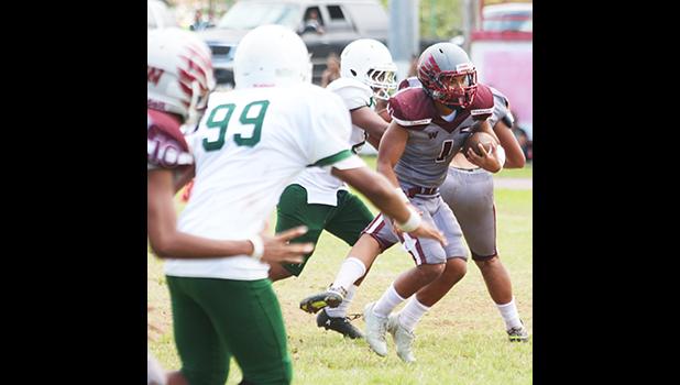 Koison Ozu (#1) of Tafuna dancing through midfield, and looking towards the goal line as he runs an 88-yard reception all the way to the end zone for the opening touchdown during a JV game against the Lions. Ozu led the Warriors to a 34-22 victory.  [photo: TG]