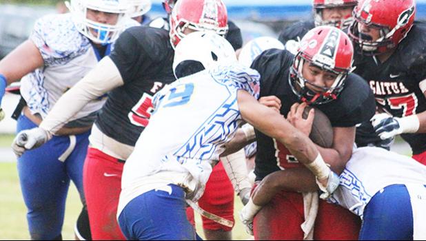 Vikings quarterback, Vito Kitiona was devoured by the Sharks defensive unit during the opening half of their Varsity match up last Friday evening at the Veterans Memorial Stadium – the Samoana Sharks defeated the Vikes 14 - 12 — a stunning win. [photo: TG]
