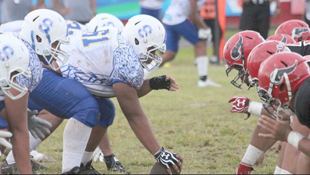 Samoana Sharks offensive line setting up to hit against the Vikings in the opening play of the game during their Varsity match last Friday evening at the Veterans Memorial Stadium.  [photo: TG]