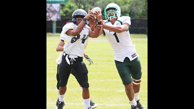 A long pass intended for (#1) of the Lions is intercepted by Nu’uuli Wildcats cornerback (#24) near the sidelines during the second half of their Junior Varsity game this past Saturday. [photo: TG]