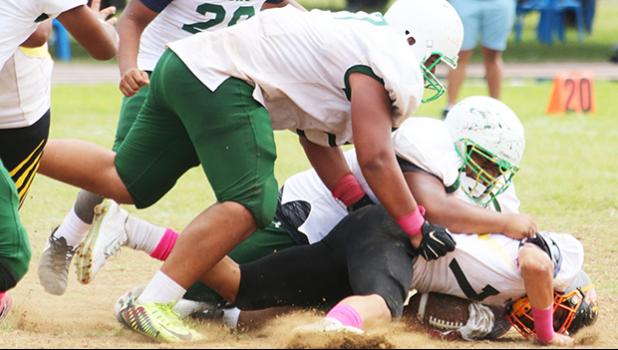 Nu’uuli Wildcats quarterback is immediately sacked hard in the backfield by Cyan Fiatoa during the final quarter of their scoreless JV game that was held this past Saturday morning at the Veterans Memorial Stadium.  [photo: TG]