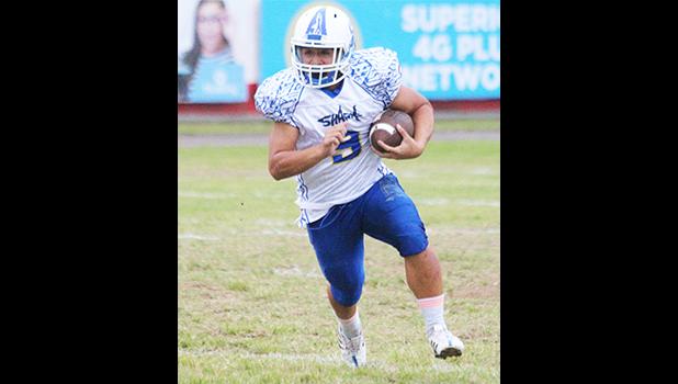 Louis Malala Jr. carrying the ball for the Samoana Sharks during the opening quarter of their varsity match up against the Lions last Thursday evening. Malala scored the opening touchdown of the game and the only offensive touchdown for Samoana, who beat Leone 14-0. [photo: TG]