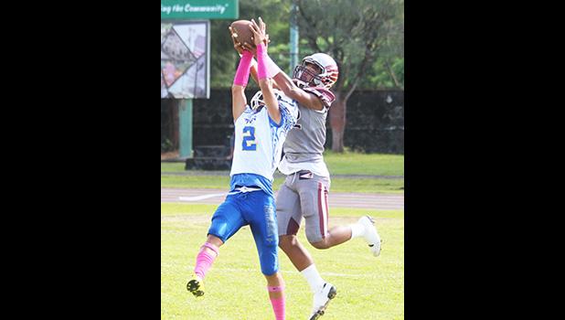 Fitu Amani intercepts a pass from Mauigoa inside the end zone – literally going up for the grab and taking it away from Pa’apa’a Mauigoa for a touchback - during the opening quarter of their JV match last Saturday morning. Amani helped the Sharks to a 8-6 win. [photo: TG]