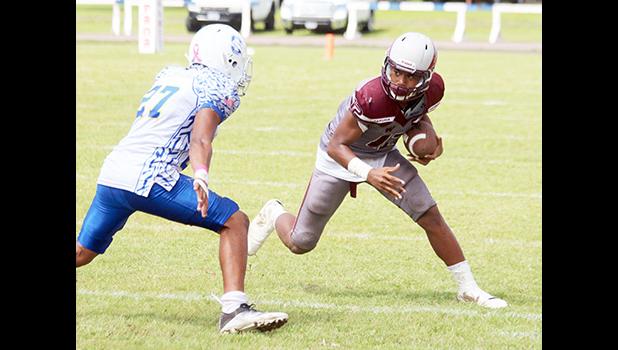 Pa’apa’a Mauigoa of the Warriors trying to make a move against a Samoana defender during their JV match up last Saturday – the Warriors lost for the second time this regular season to the Samoana Sharks, this time by two points 6-8. [photo: TG]