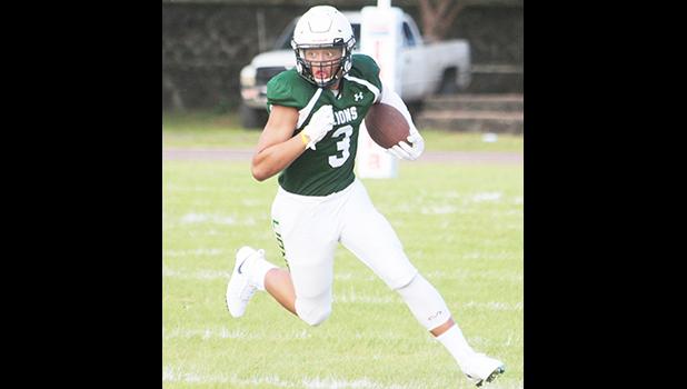 Iverson Ta’ase of the Lions running the ball downfield for the Lions, during the opening half of their varsity match up against Tafuna. Ta’ase led the Lions to a 44-26 win over the Warriors.  [photo: TG]