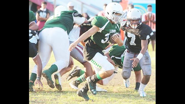 Nathan Harmon taking this one straight up the middle and into the end zone for his first touchdown of the game during the first half of play in their varsity match up against Tafuna last Friday evening. [photo: TG]