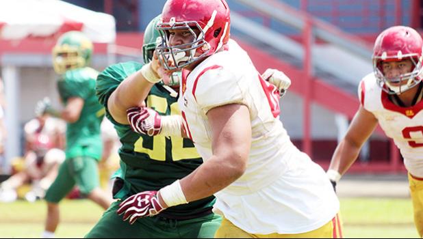 Tafuna Warriors Sophomore Francis Mauigoa breaking through Leone Lions wall