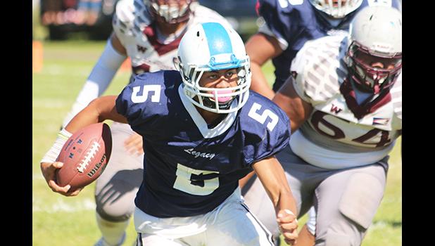 Fitu Amata Jr. of Samoana carrying the ball