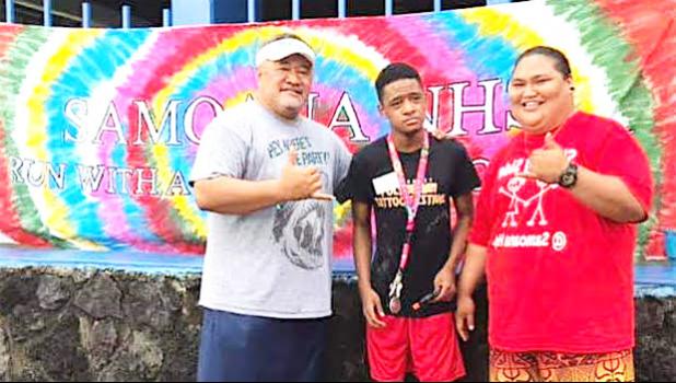 Samoana HS principal Rod Atafua with Special Education teacher Mafutaga Taase and SPED student DeAndre Chen