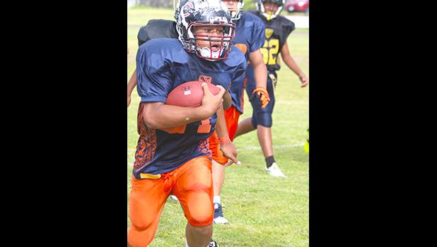 Vaifanua Peko-Vai of the Bears at the sidelines, and storming towards the end zone. He was brought down shy of the goal line, but carried this one for a huge gain for the Bears in their win against the Steelers to secure them a spot in the championship game this Saturday. Peko-Vai helped the Bears in a  20-6 victory over the Steelers. [photo: TG]