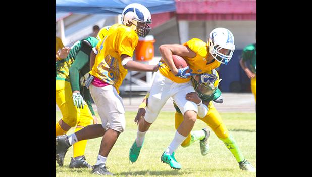 Sam Mikaele breaking a tackle by Alfred Maiava just before he broke out to the open field to score his first touchdown of the game in the final quarter of play. Mikaele helped the Rams in their 22-14 win against the Packers. [photo: TG]