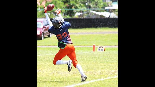 Prodieus Lutu-Fuga concentrating on securing this catch which he did – for the AYFS Bears' second touchdown of the game in the first quarter of play against the AYFS Rams during their Championship battle last Saturday at the Veterans Memorial Stadium. Prodieus Lutu-Fuga led the Bears to their third championship title with a 30-18 victory.  [photo: TG]