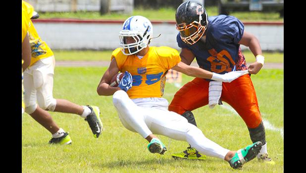 Sam Mikaele of the Rams is stopped immediately in the backfield by Foalima Tatupu of the Bears during the opening half of their championship match up last Saturday. [photo: TG]