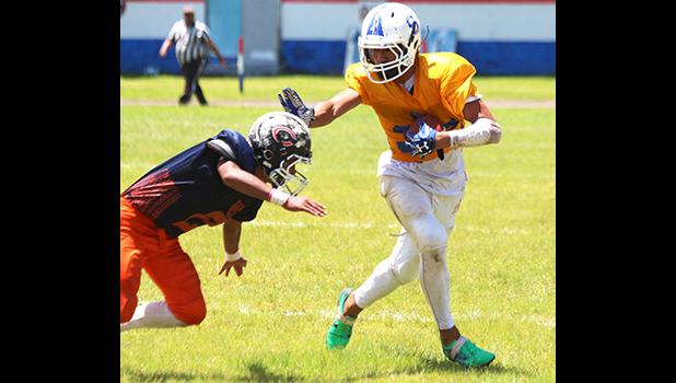 After securing a catch in the second half of play, Sam Mikaele is caught trying to stiff arm the last defender between him and the end zone to score his first touchdown of the game during the second half of play.  [photo: TG]