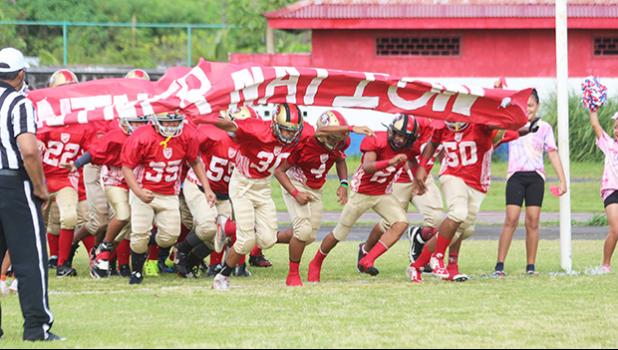 The AYFS 49ers ‘Niner Nation’ running out to the field for the first time this season to face the AYFS Bears during the season opener last Saturday morning at the Veterans Memorial Stadium. [photo: TG]
