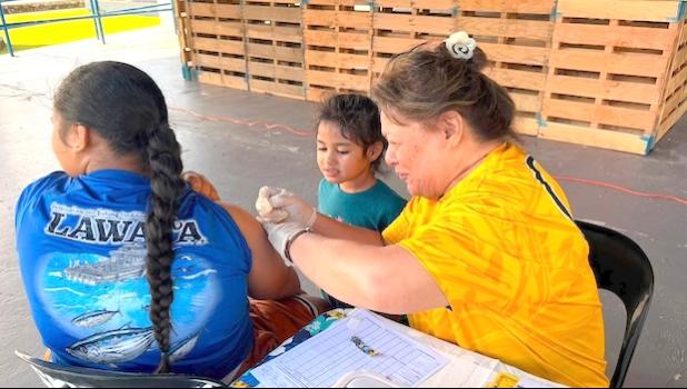 DoH nurse and student getting a vax.