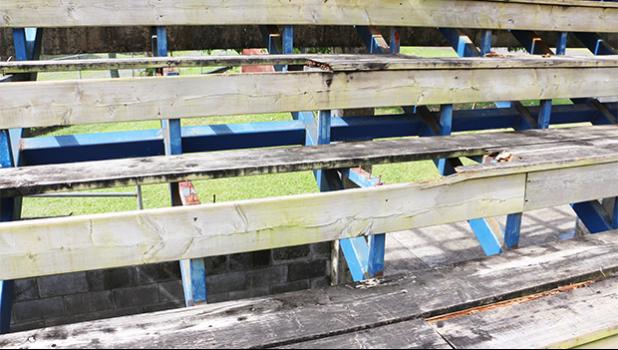 The wooden seating area at the baseball field is in such a rotted state, thanks in part to vandalism that has also left the seats with burn marks, and broken/splintered wood pieces. [photo: THA]