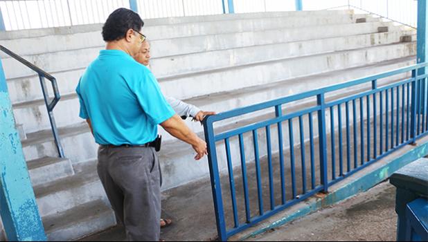 Parks & Rec director Maeatanoa Pili Gaoteote and a staff member checking out the loose metal railing at the baseball field that parents were complaining about being a hazard to kids who utilize the field for sporting events, most recently, the summer baseball clinics. See story for full details. [photo: THA]