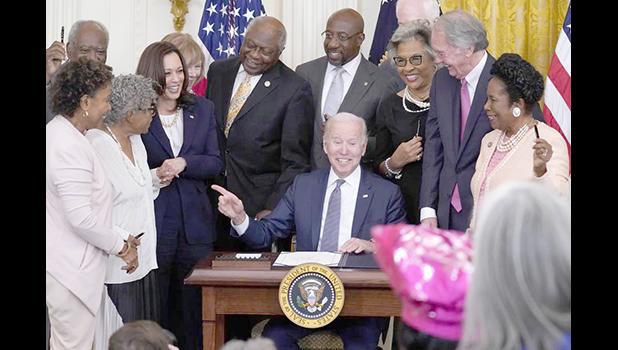 President Joe Biden points to Opal Lee after signing the Juneteenth National Independence Day Act