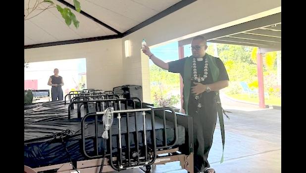 Father Jeudiel Galvo blesses the beds