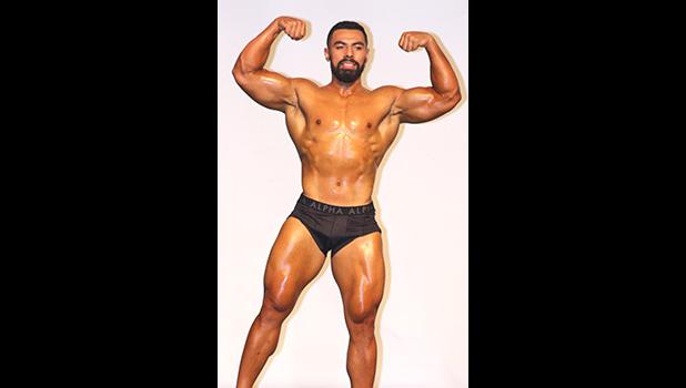 Guest Poser during last Saturday night’s 2018 Sau Ia Body Building Championship, John Lemoa – the 2017 Champion of Samoa’s Body Building competition, showing off his double biceps for the crowd. [photo: TG]